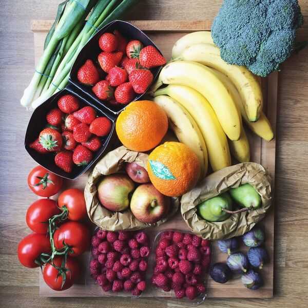 Fresh vegetables and simple ingredients arranged on a kitchen table